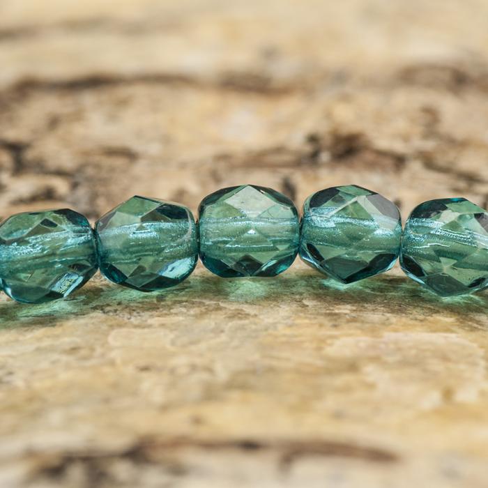 Glaspärla facetterad 4,5x5 mm, Mörk turkos (25st)